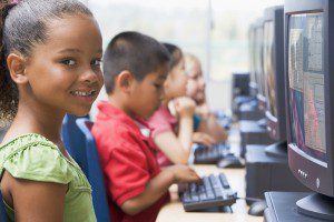 Kindergarten children learning how to use computers.