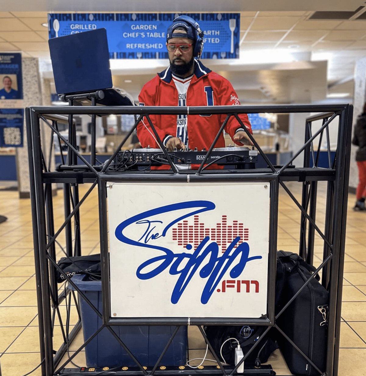 The Sipp FM DJ booth with the station logo